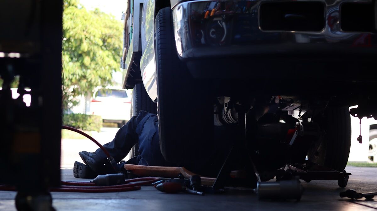 Truck technician performing maintenance on a semi truck